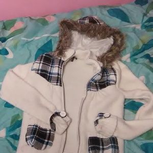 A winter jacket that has a fuzzy hood.